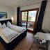 Pension zum Mühlrad in Millstatt guest room with twin bed, balcony door, and lake view