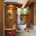 Landhotel Christopherhof in Grafenwiesen spa area with wooden saunas and a stone basin fountain