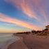 Wyndham Deerfield Beach Resort on Deerfield Beach with a wide sandy shoreline and ocean sunset