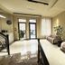 Yerevan Deluxe Hotel lobby in Yerevan with seating area, potted plants and glass entry doors