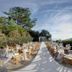 Montana Pine Resort in Fethiye: outdoor wedding aisle with white chairs, draped fabric, and mountain views