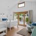 Mar Bella Boutique Hotel & Spa in Rehoboth Beach, bright twin-bedded room with sliding glass doors to a patio
