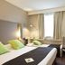 Campanile Tours Sud - Chambray-Les-Tours guest room with twin beds and a window in Chambray-lès-Tours.