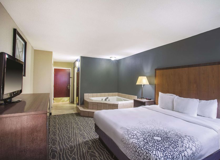 La Quinta Inn by Wyndham Richmond South room with king bed, sofa bed, and whirlpool tub in Richmond