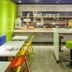 Ibis Budget Saint Omer Centre breakfast area with colorful stools and tables