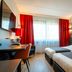 Bastion Hotel Dordrecht Papendrecht room in Dordrecht with twin beds, desk, and harbor mural