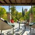 Seda Club Hotel Granada terrace seating with garden views and a distant tower