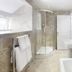 Hawksmoor Guest House in Windermere bathroom with curved glass shower, pedestal sink and bathtub