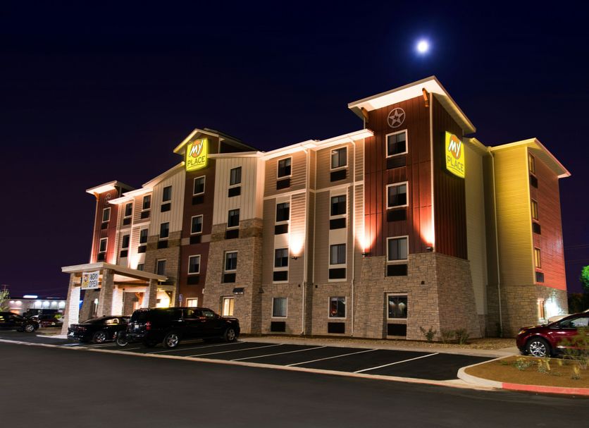 My Place Hotel - Amarillo, TX exterior at night with illuminated facade and parked cars