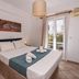 Cyclades Beach Apartments in Platis Gialos bedroom with double bed, balcony doors and natural light