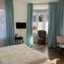 Hotel Markgräfler Hof, Badenweiler: bright guest room with bay windows, blue curtains and armchairs