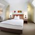 Hotel am Jakobsmarkt Nuremberg guest room with double bed, desk, and modern minimalist décor