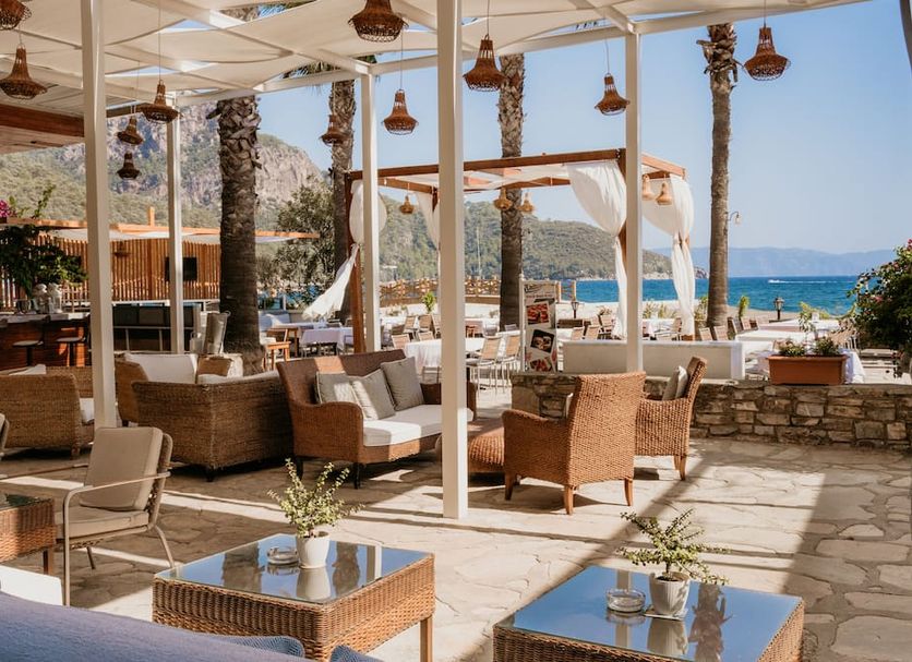 Ekincik Beach Hotel in Ekincik with shaded seaside terrace seating and ocean views