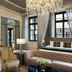 H15 Palace, a Luxury Collection Hotel, Krakow guest room with fireplace, chandelier, and tufted sofa