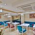 Glamour Hotel Istanbul Sirkeci lounge with blue tufted seating and white tables in Istanbul