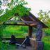 Pousada Villa Das Pedras in Pirenópolis, rustic lakeside pavilion with stone benches and greenery