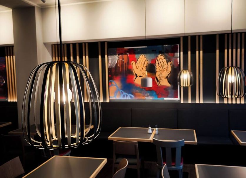 CVJM Düsseldorf Hotel & Tagung lounge with modern pendant lights and table seating in Düsseldorf