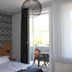 Hotel am Kurpark in Bad Lauterberg guest room with bed, patterned wall, and balcony door