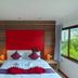 Patong Max Value Hotel in Patong guest room with red headboard, double bed, and large window view