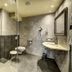 Hotel Goldener Adler in Innsbruck bathroom with walk-in shower, toilet, sink, and large mirror