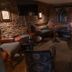 The Carpenters Arms Bristol lounge with stone walls, arched windows, sofas and round tables