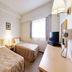 HOTEL AZ Fukuoka Amagi Inter guest room with two single beds, TV, and window in Asakura