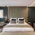 1.75 Paris La Source in Paris, stylish hotel room with arched upholstered headboard and king bed