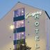 Hotel Göingehof in Hässleholm exterior with illuminated vertical hotel sign at dusk