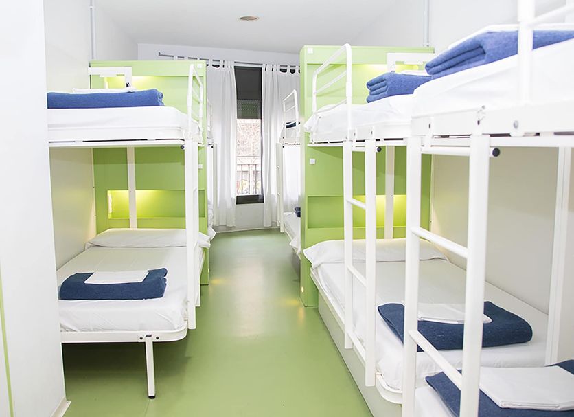 Sant Jordi Hostels Sagrada Familia in Barcelona, bright dorm room with white bunk beds and green floor