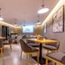 Home Inn Neo Lanzhou City Museum Dongfanghong Plaza Wanxiang City dining area with tables, chairs, and wall art