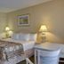 Vagabond Inn Ventura guest room with king bed, lamps, desk and chair in Ventura