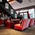 The Wellem in Düsseldorf lounge with red velvet seating, staircase, and large windows