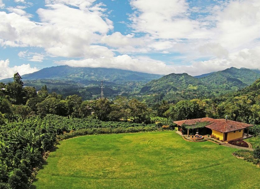 Los Establos Boutique Hotel in Boquete with a lush lawn and mountain valley views