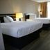 Heritage Inn & Suites by Capital O Baton Rouge I 10 guest room with two beds and window drapes