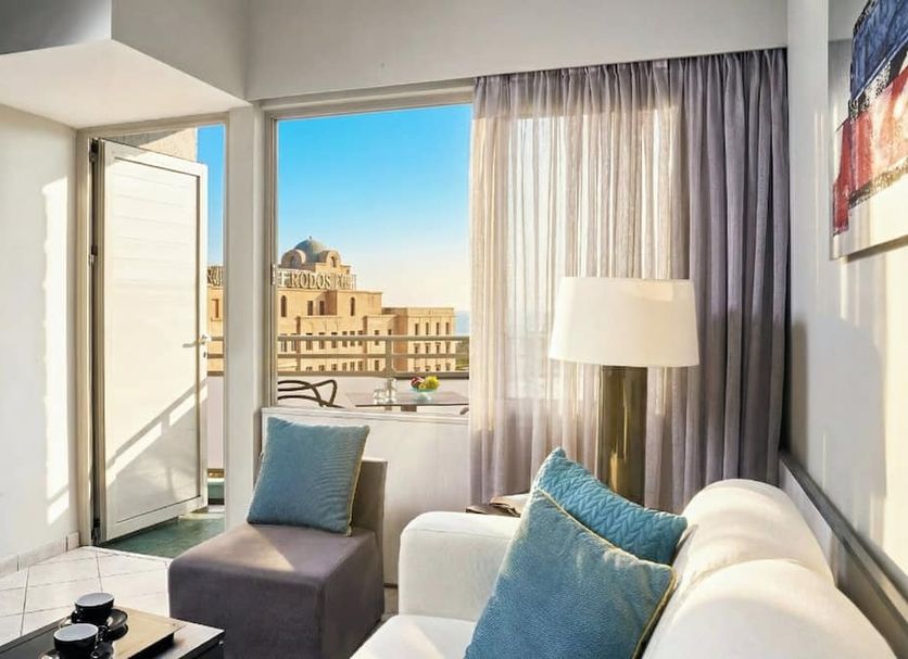 Aquamare City And Beach in Rhodes with balcony-style city view, lounge chair and floor lamp