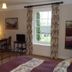 Manor Farm B&B in Marlborough guest room with bed, desk, window, and garden view