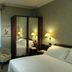 Rizzi Aquacharme Hotel & Spa room in Darfo Boario Terme with bed, wardrobe, desk and chair