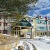 Homewood Suites by Hilton Mont-Tremblant Resort entrance in snowy Mont-Tremblant with colorful chalet-style buildings