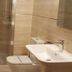 Hotel Naranjo De Bulnes bathroom with shower enclosure, sink, and toilet in Las Arenas