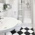 Hotel Weisses Haus Bad Kissingen bathroom with glass shower, pedestal sink and black-and-white tile floor