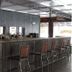 Rustic Western Themed Hotel in Tipton bar with high stools and wood-paneled interior