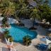 Pineapple Beach Club Antigua Adults Only in Willikies, two lagoon-style pools with palm trees and lounge chairs