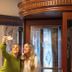 Guests take a selfie inside Boutique Hotel Corona in The Hague, with wood-paneled decor and marble walls.