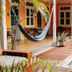 Boutique Hotel 't Klooster in Willemstad: courtyard pool with hammock, lounge chairs and colorful colonial walls
