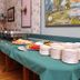 Breakfast buffet setup at Victoria Resort And Bed & Breakfast in South Haven with plates, pastries and fruit