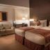 Asdal Boutique Hotel Seef, Manama: twin beds in a modern hotel room with bedside lamps and seating area