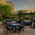 Homewood Suites by Hilton Pittsburgh-Southpointe in Canonsburg outdoor patio with tables and pergolas at sunset
