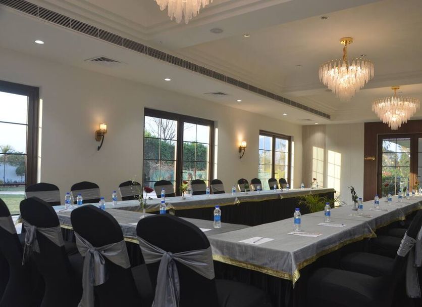Black Mango Resort in Kāla Āmb meeting room with U-shaped banquet table and chandeliers