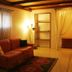 Residence Palazzo Baldi in Galatina: warm guest room with sofa, rug, shelves, and curtained window