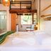 Velinn Pousada Canoa Ilhabela room with loft bed, hanging lights and tropical decor in Ilhabela